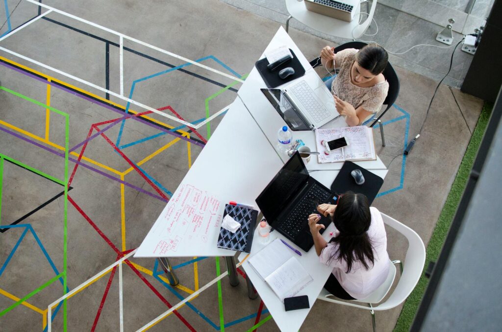 Two woman in a table working on Marketing Your White Label Web Design Services