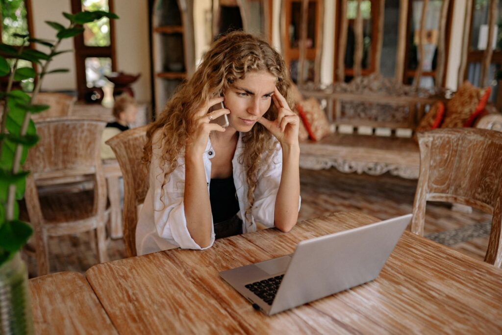 A girl with a curly blonde hair thinking Which Platform is Right for her Business: Sellvia vs Shopify