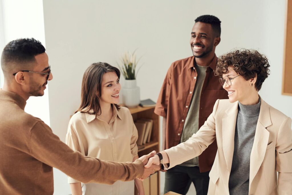 Building Trust and Credibility - A group of co-workers happily shaking each others hand